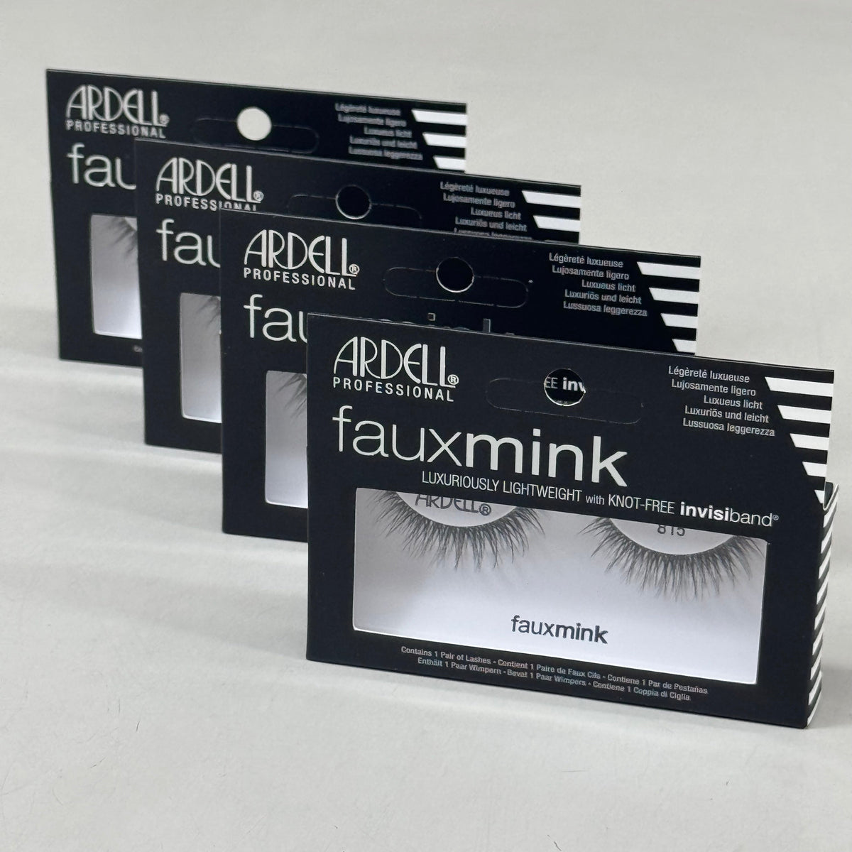 Multiple packages of Ardell Professional faux mink eyelashes on a light gray background
