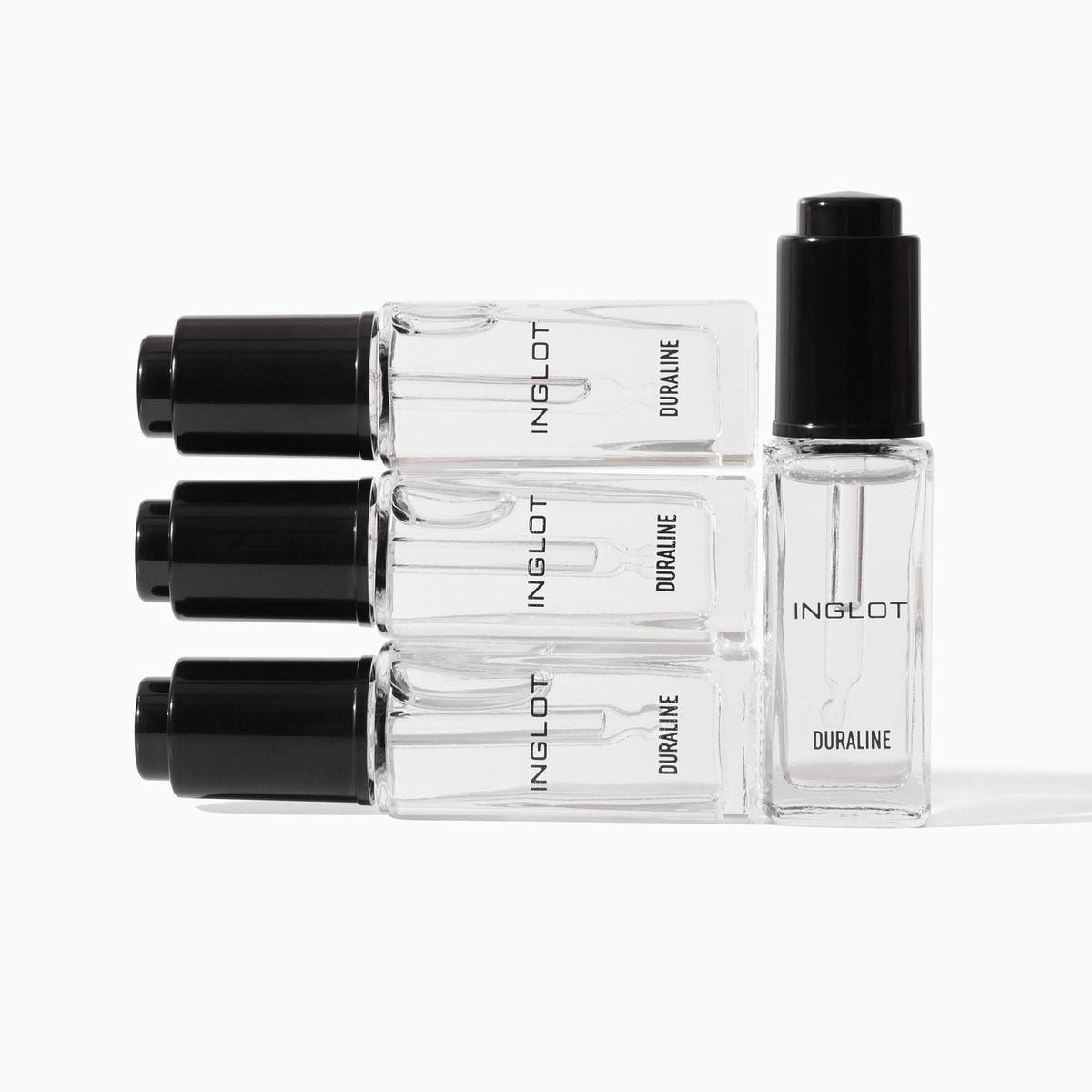 Set of Inglot nail polish bottles on a white background