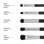 Set of makeup brushes with labels on a white background