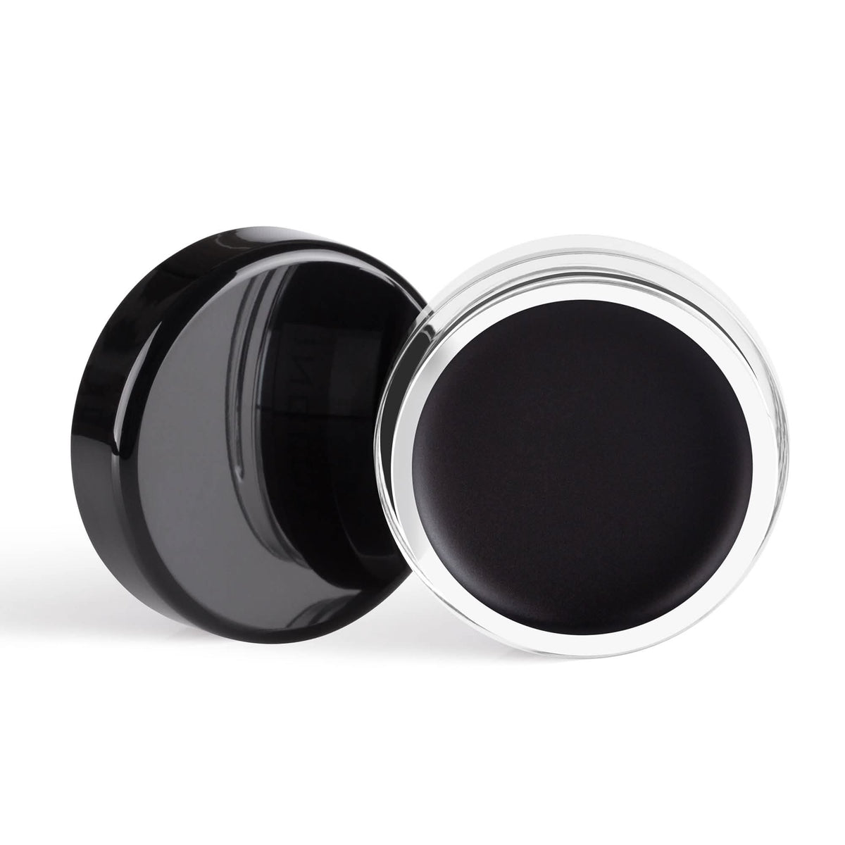 Black cosmetic cream in a round container with a black lid on a white background