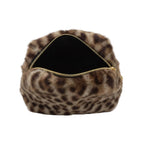 Close-up of a fur-lined pouch with a gold zipper on a marble surface