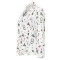 A white long-sleeve button-up shirt with a festive Christmas and holiday-themed print featuring red lipstick tubes, candy canes, green holly leaves, red bows, and small red stars.