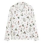 A long-sleeve button-up pajama shirt with a white base and a festive Christmas-themed print featuring red bows, green holly, candy canes, and red lipstick tubes, shown against a plain light gray background.