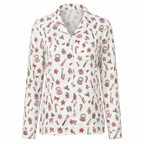 A long-sleeve collared button-up shirt with a festive Christmas print featuring candy canes, gingerbread men, presents, and stars on a white background.