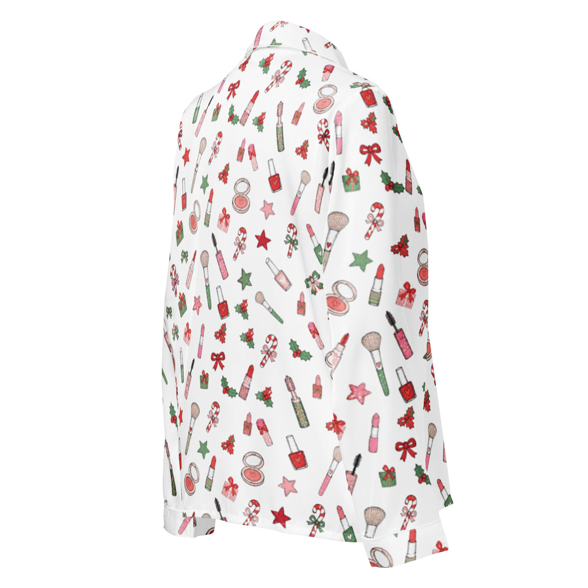 A white long-sleeve button-up shirt with a festive Christmas and beauty-themed all-over print, featuring red and green holiday motifs alongside makeup items like lipstick, brushes, and candy canes.