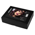 A black rectangular wig box with a glossy front label showing a model with dark purple hair and magenta lipstick, photographed on a white background.