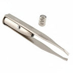 Metallic tweezers with a cylindrical component on a white background