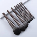 Set of makeup brushes with brown handles on a white background