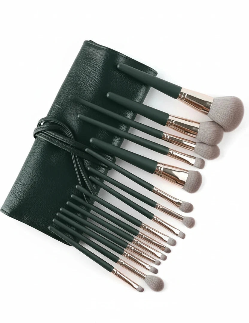 Set of makeup brushes with a black leather case on a white background