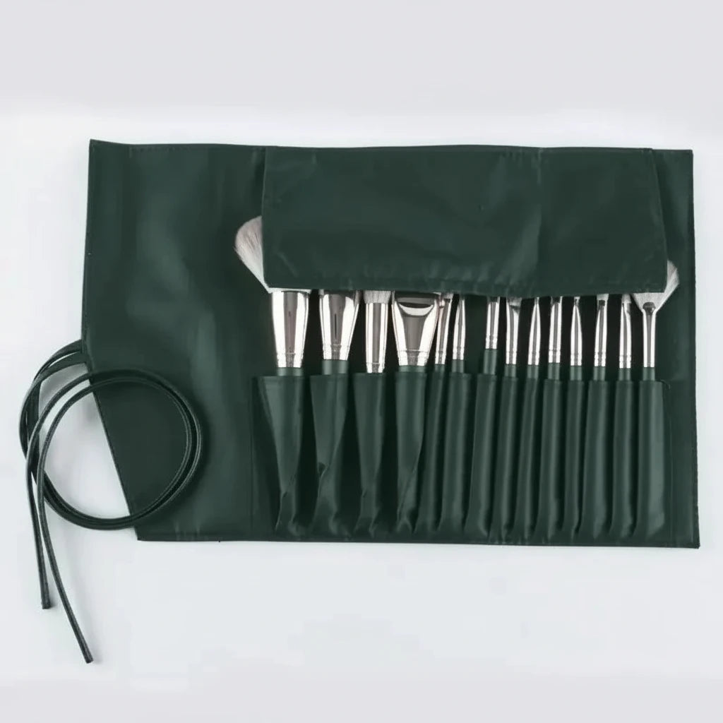 Set of paintbrushes in a green case on a white background