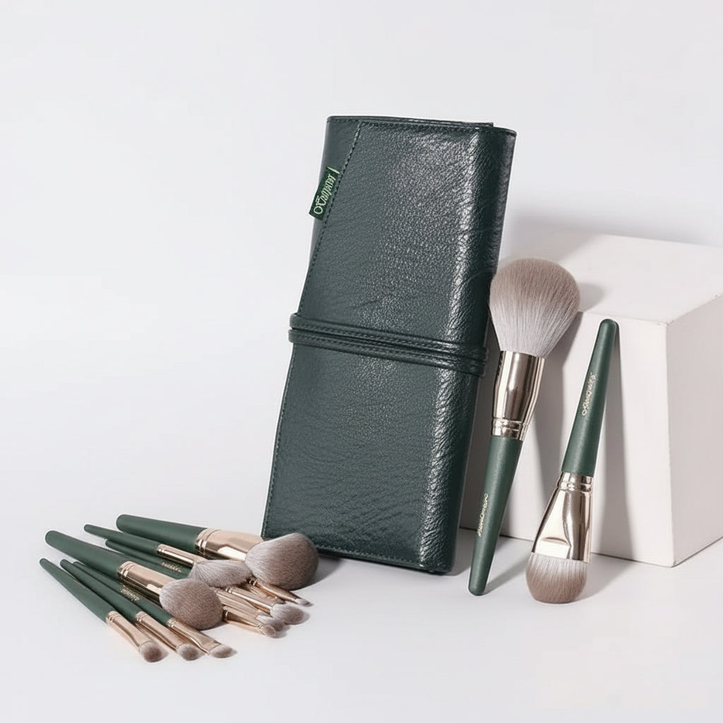 Green makeup brush set with a closed wallet on a light gray background