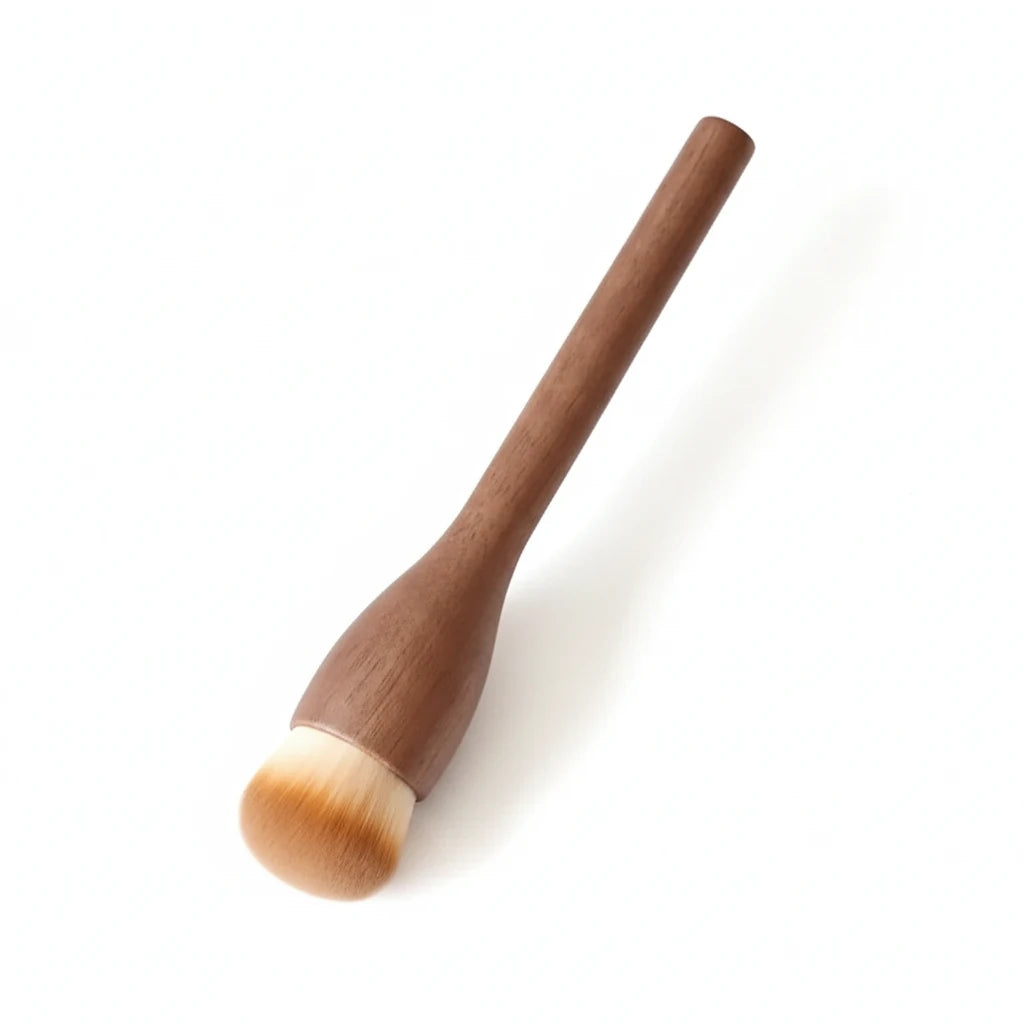 A makeup foundation brush with a medium brown wooden handle and soft bristles in beige and white, shown on a light gray background with an inset close-up of the brush head and text listing dimensions.