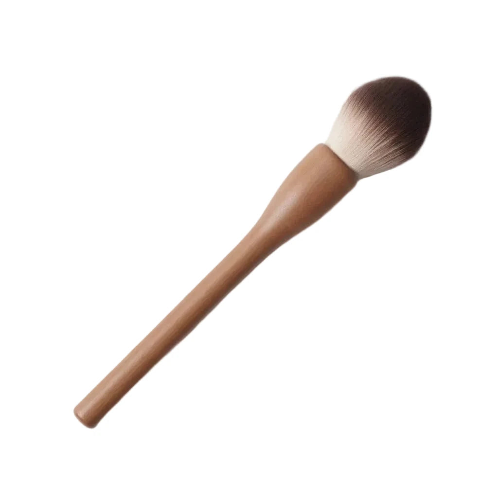 Makeup brush with wooden handle and pink bristle head on a white background